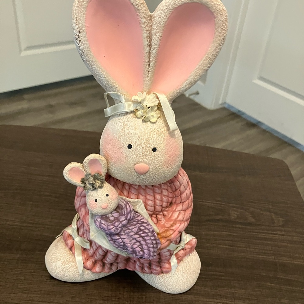 Pink decorative bunny figurine depicting a mother rabbit holding a baby Easter